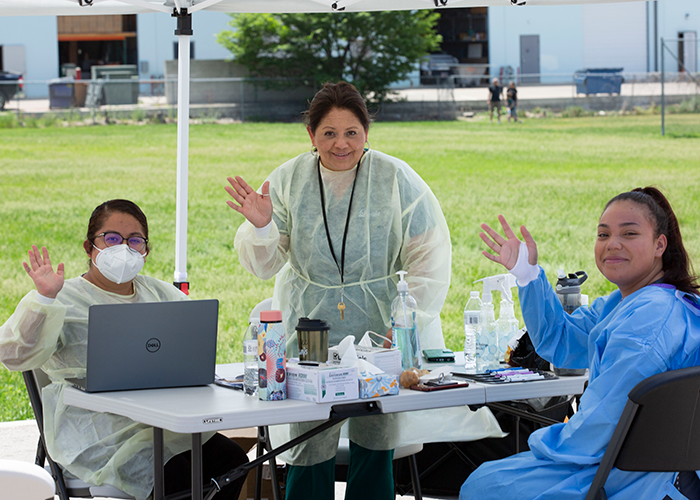 Nurses at a covid site waving